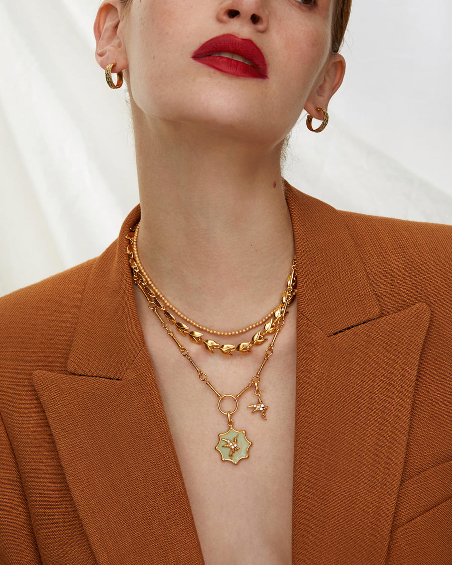 Soru jewellery, gold hoop earrings with pastel green enamel detail
