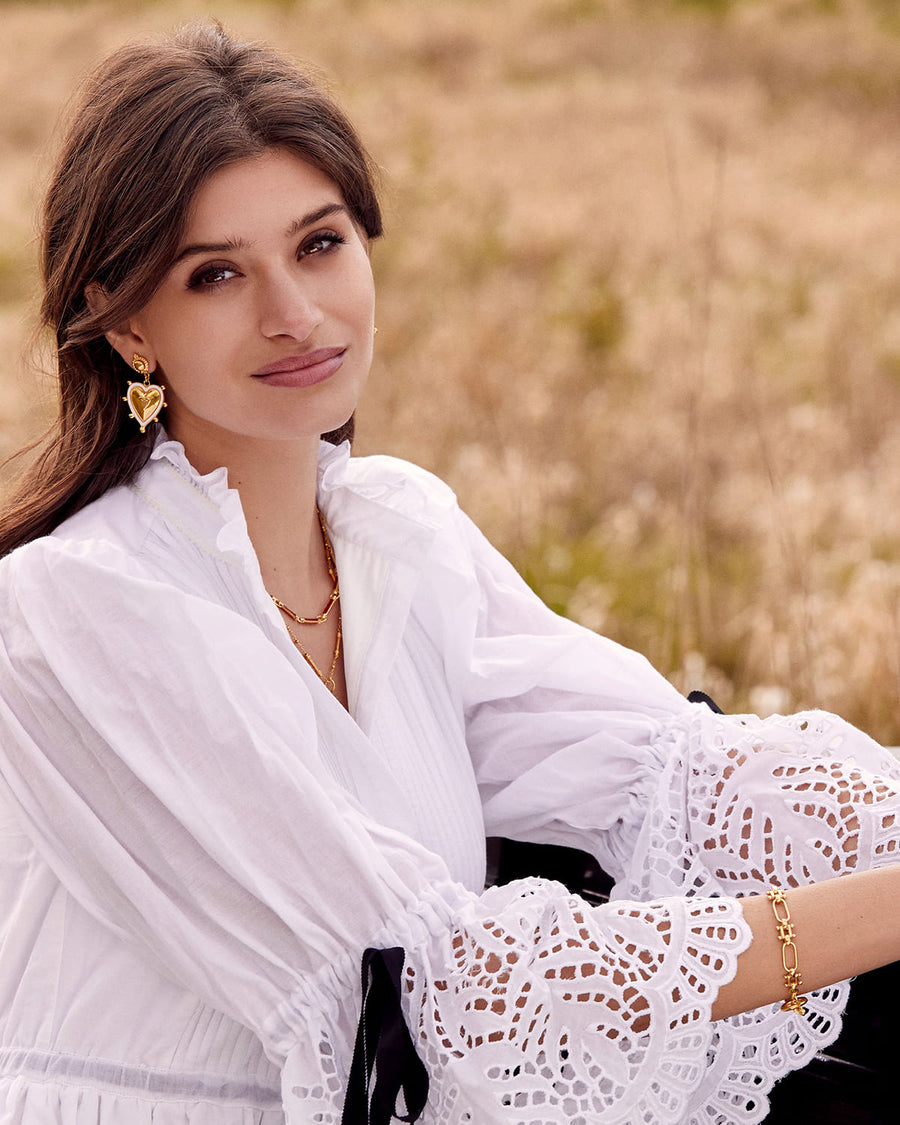 Soru Jewellery summer campaign image featuring the Sicilian heart white enamel and gold earrings